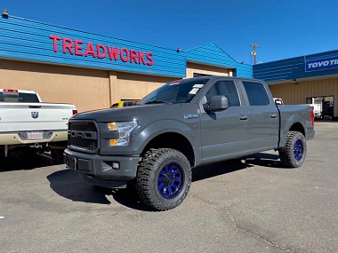 blue custom wheels and tires installed on truck in Farmington, NM